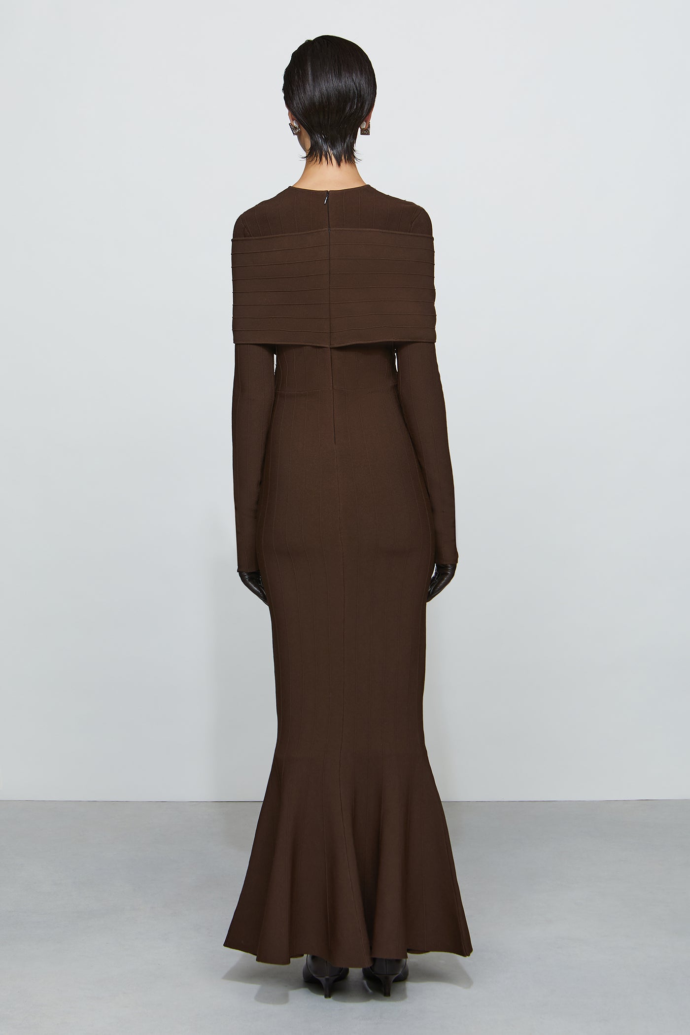 Brown dress worn by a person on a white background
